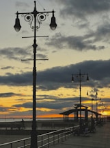 A friendly local guide smiling beside the vibrant Samaná boardwalk at sunset.