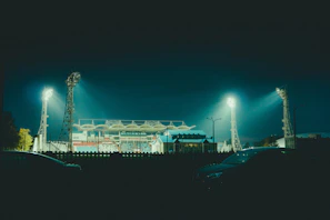 Night view of a modern stadium lit up for a World Cup 2026 group stage game