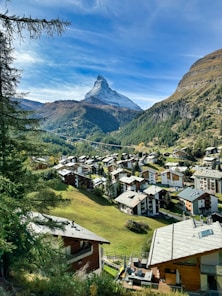 a scenic view of a village in the mountains