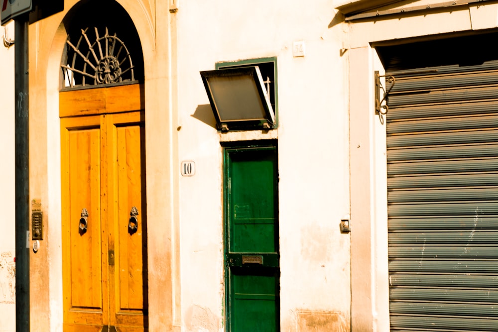 a green door and a yellow door on a building