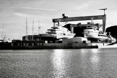 Panoramic view of a serene shipyard in the South of France with yachts in various stages of refit.