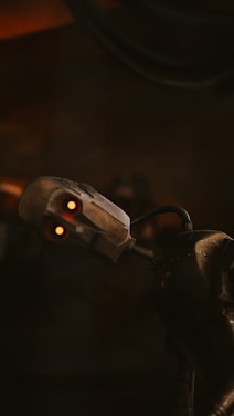 A sleek cartoon purple-and-gold robot with eyes following the cursor on a modern, smooth animated background.