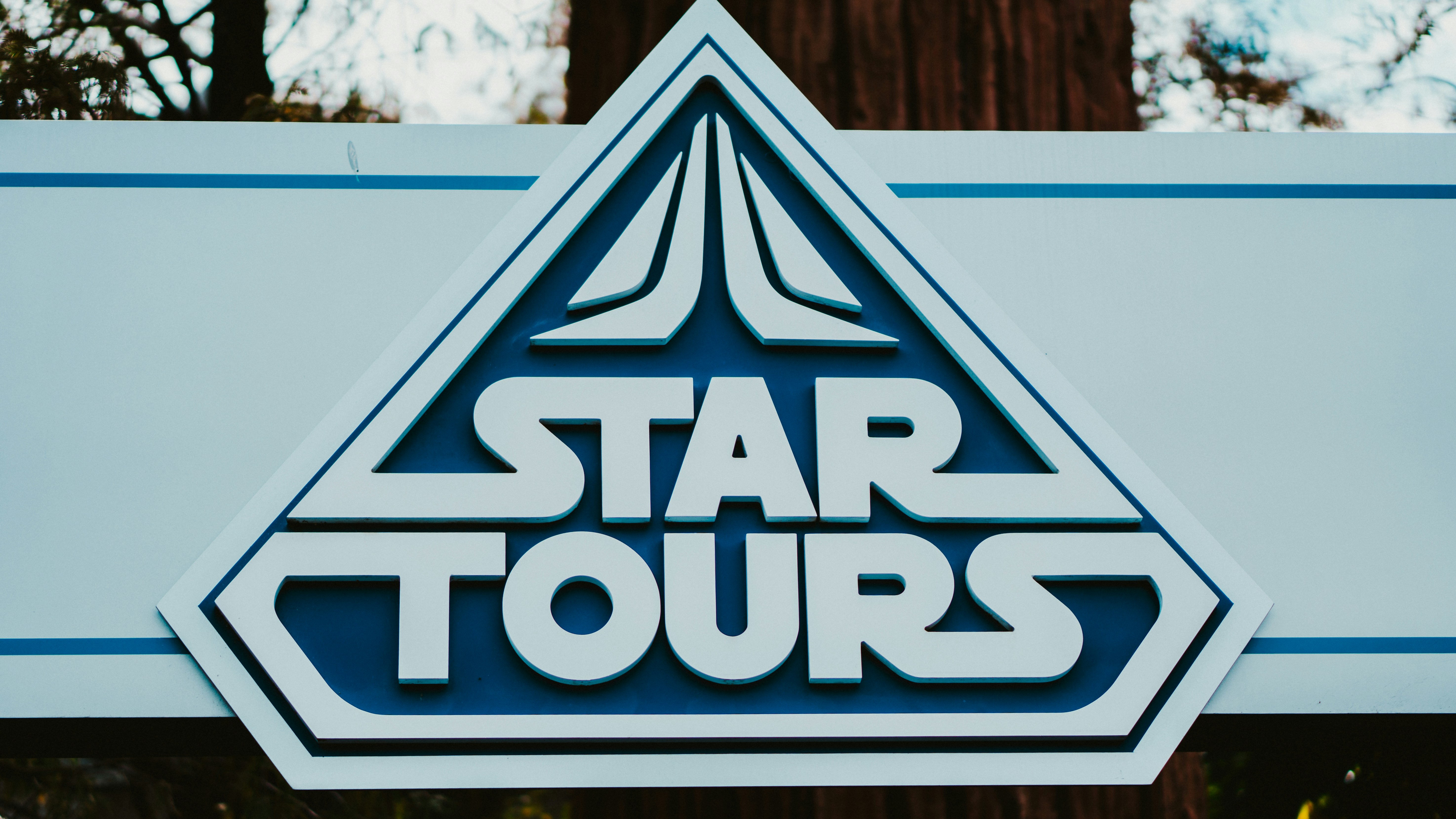 a star tours sign in front of a tree