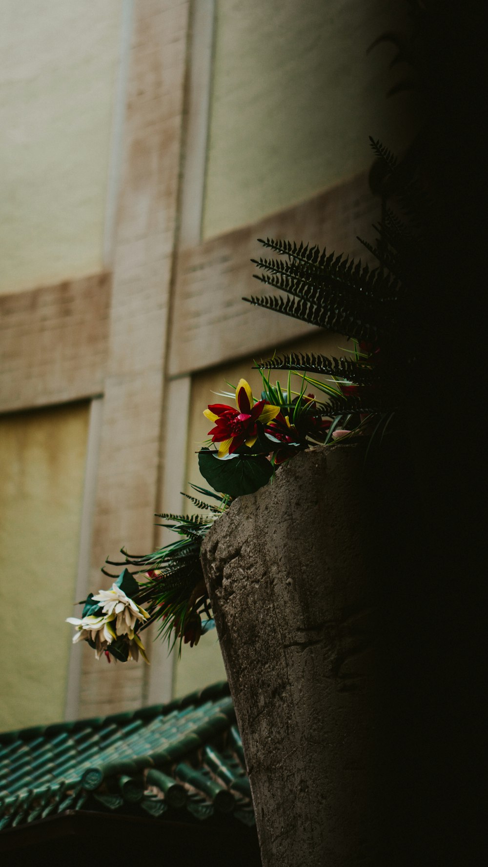 a planter with flowers on the side of a building