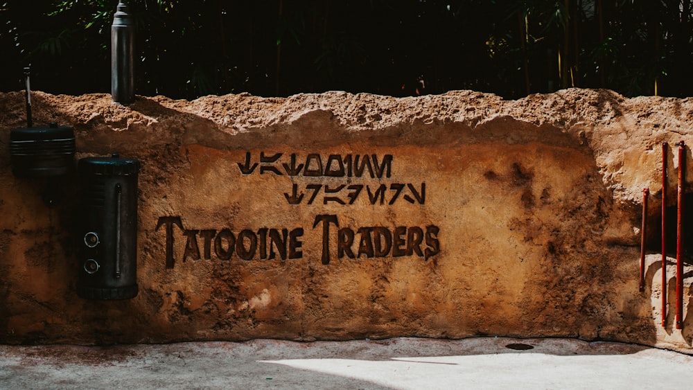 a stone wall that has writing on it