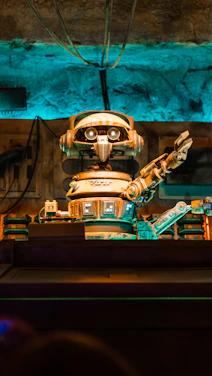 A sleek robot arm reaching out against a dark, futuristic background illuminated by electric blue lights.