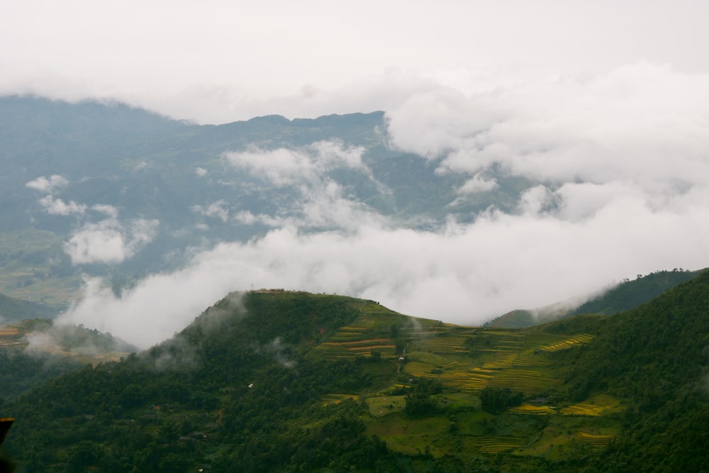 a view of a mountain range covered in clouds