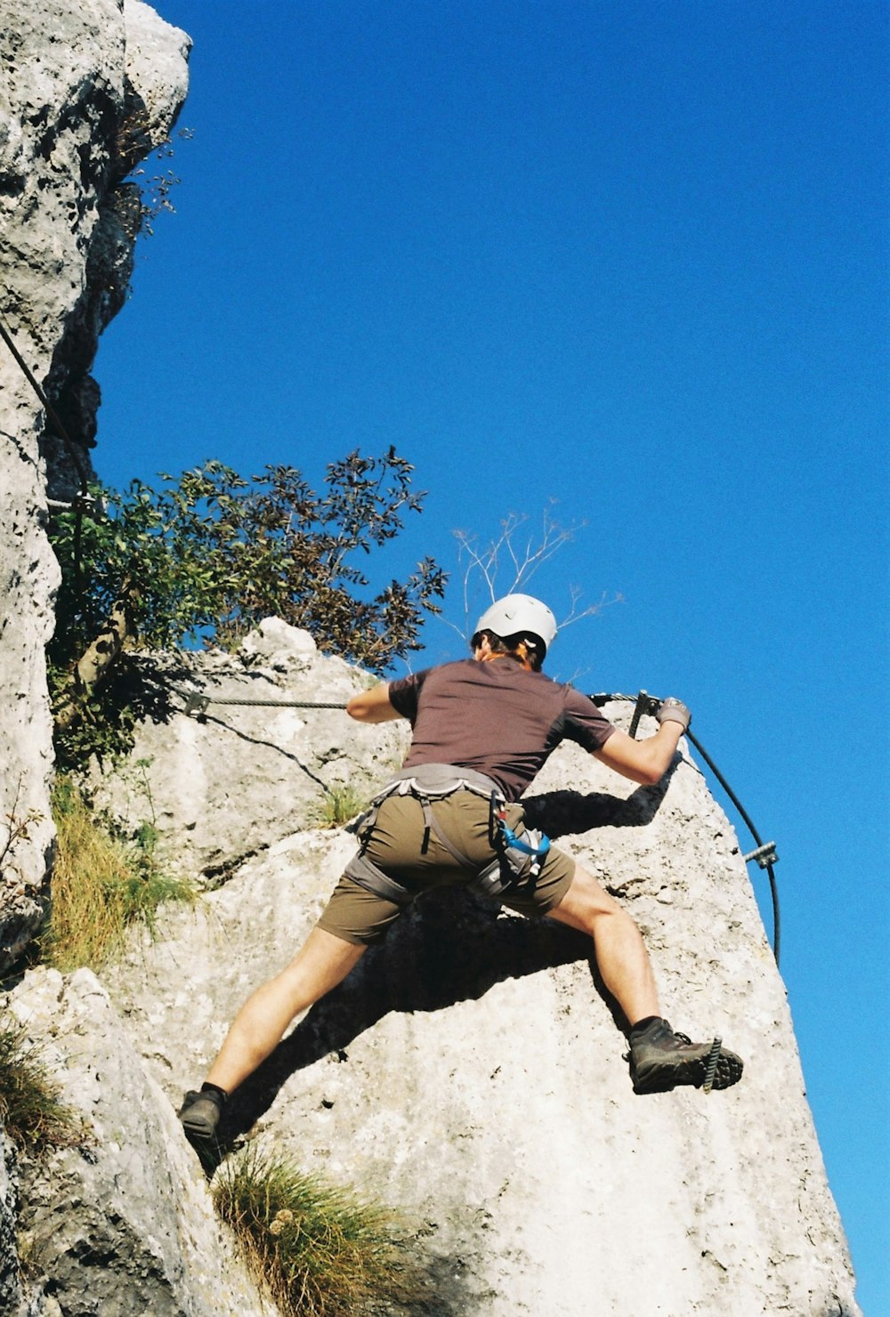 a man climbing up the side of a mountain