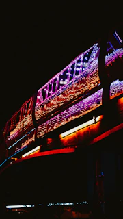 Digital art of trains weaving through a glowing network of vibrant, colorful pathways.