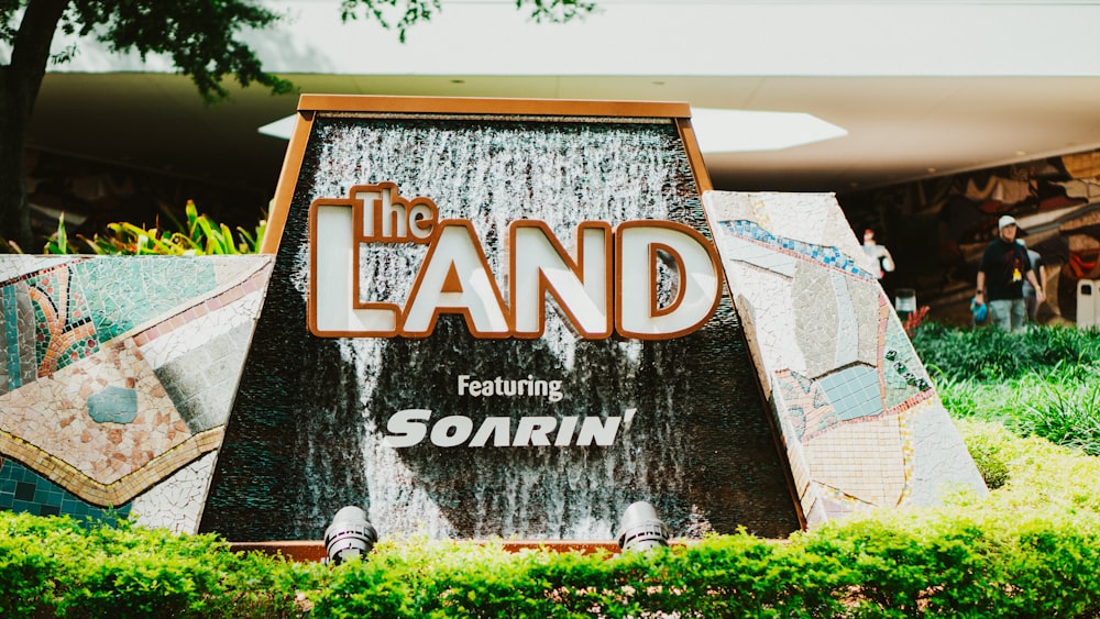 a large sign with a waterfall in the middle of it