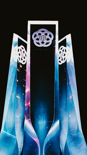 A sleek, angular architectural structure bathed in electric teal and deep obsidian lighting, symbolizing cutting-edge innovation.