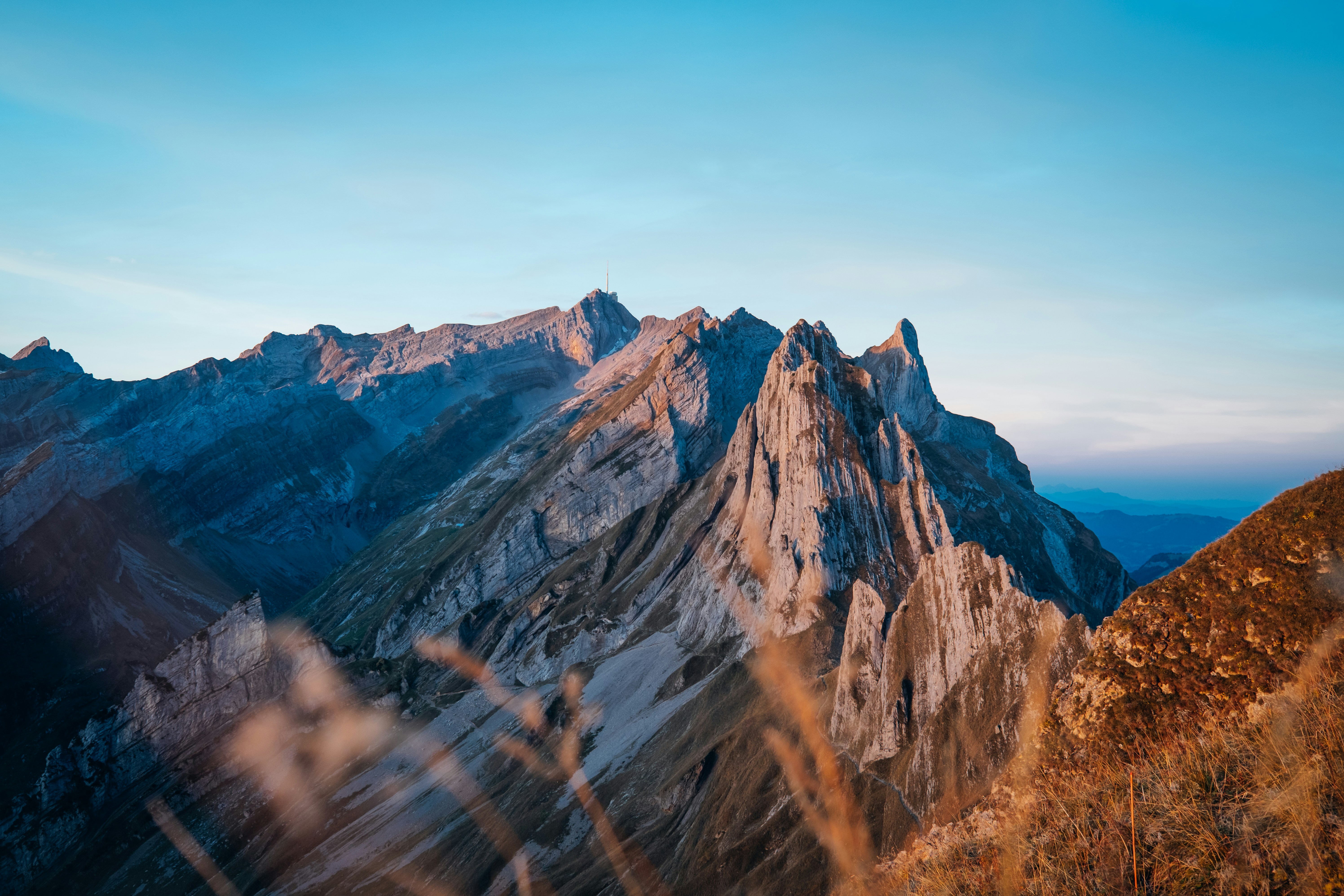 a view of a mountain range from the top of a hill, 