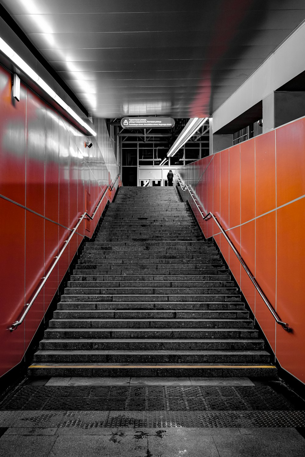 a set of stairs leading up to a red wall