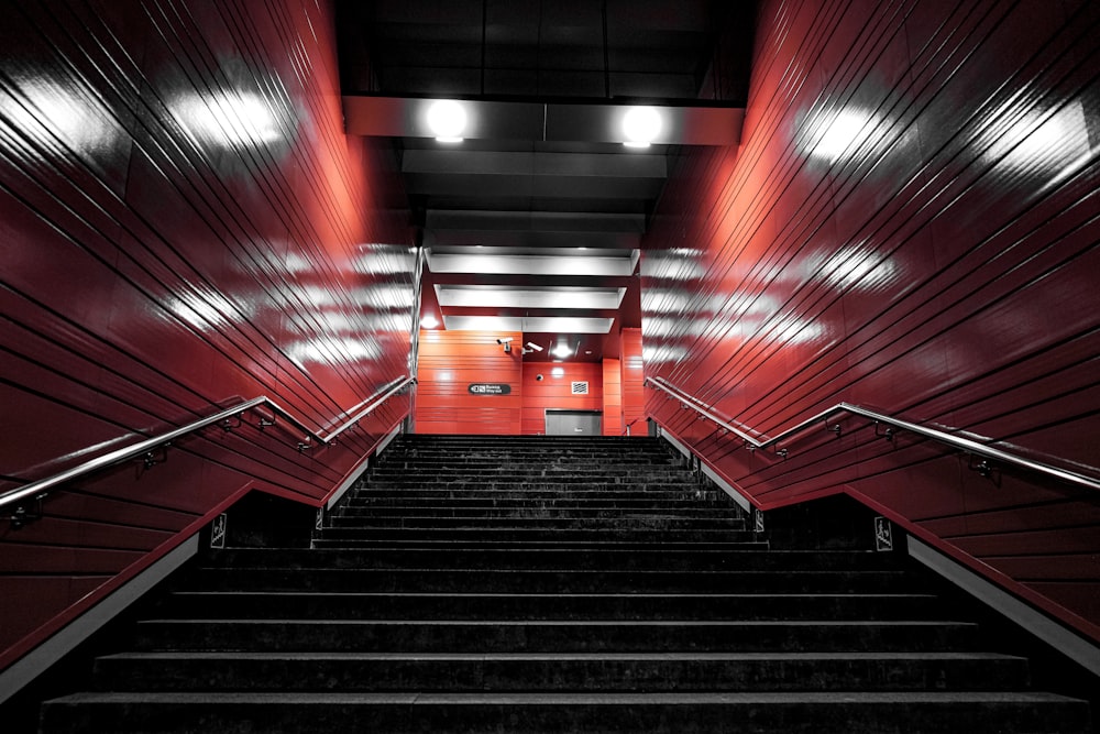 a set of stairs leading up to a red wall