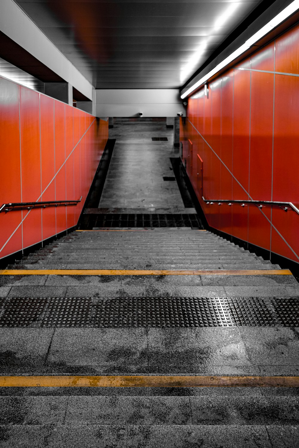 a long hallway with red walls and a yellow line