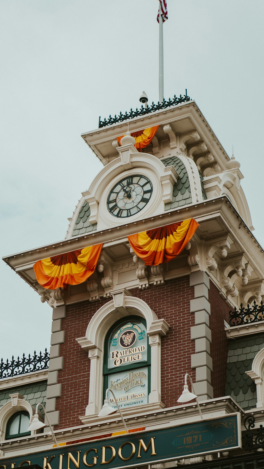 a clock tower with a flag on top of it