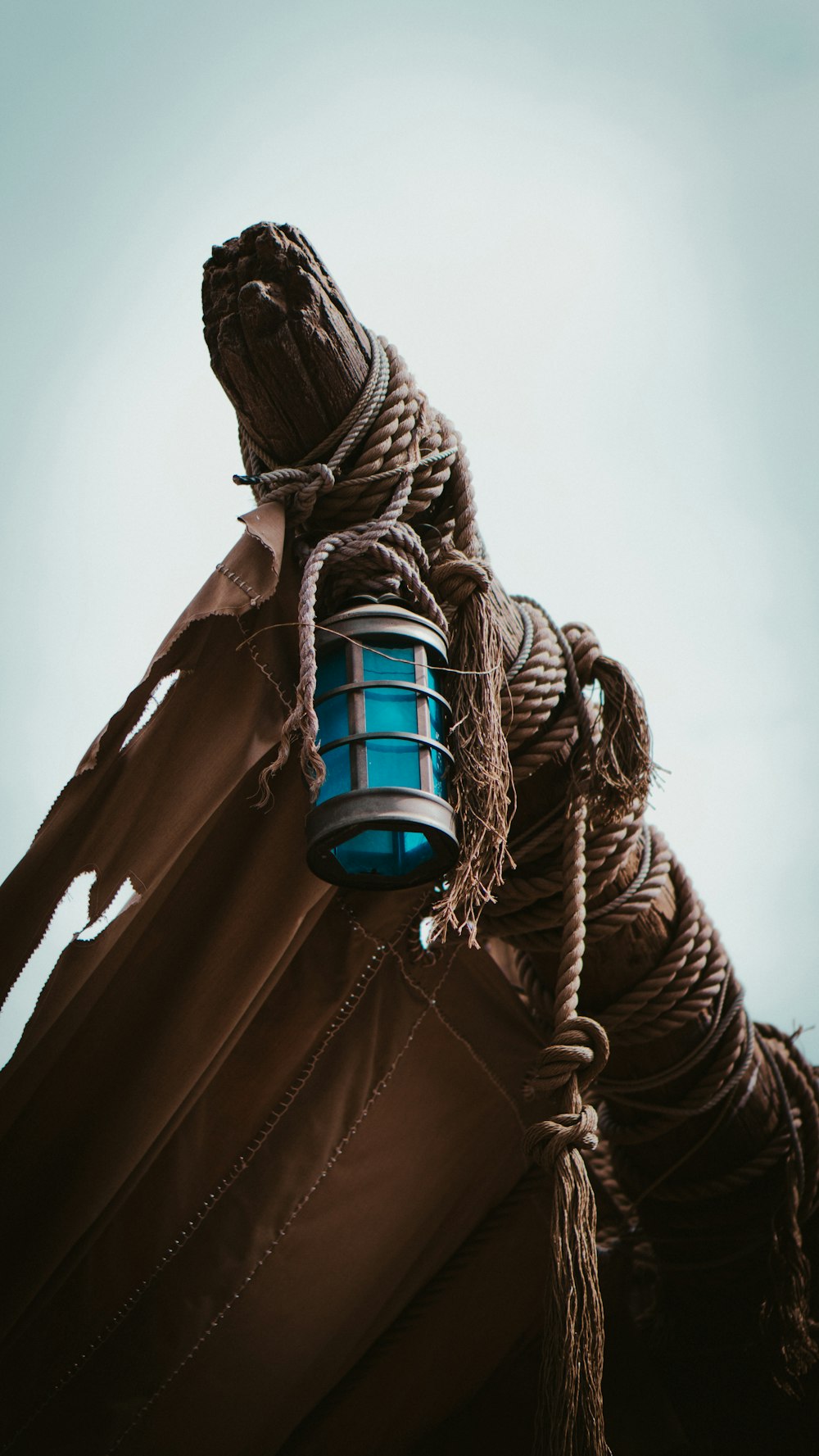 a blue lantern hanging from the side of a tall building