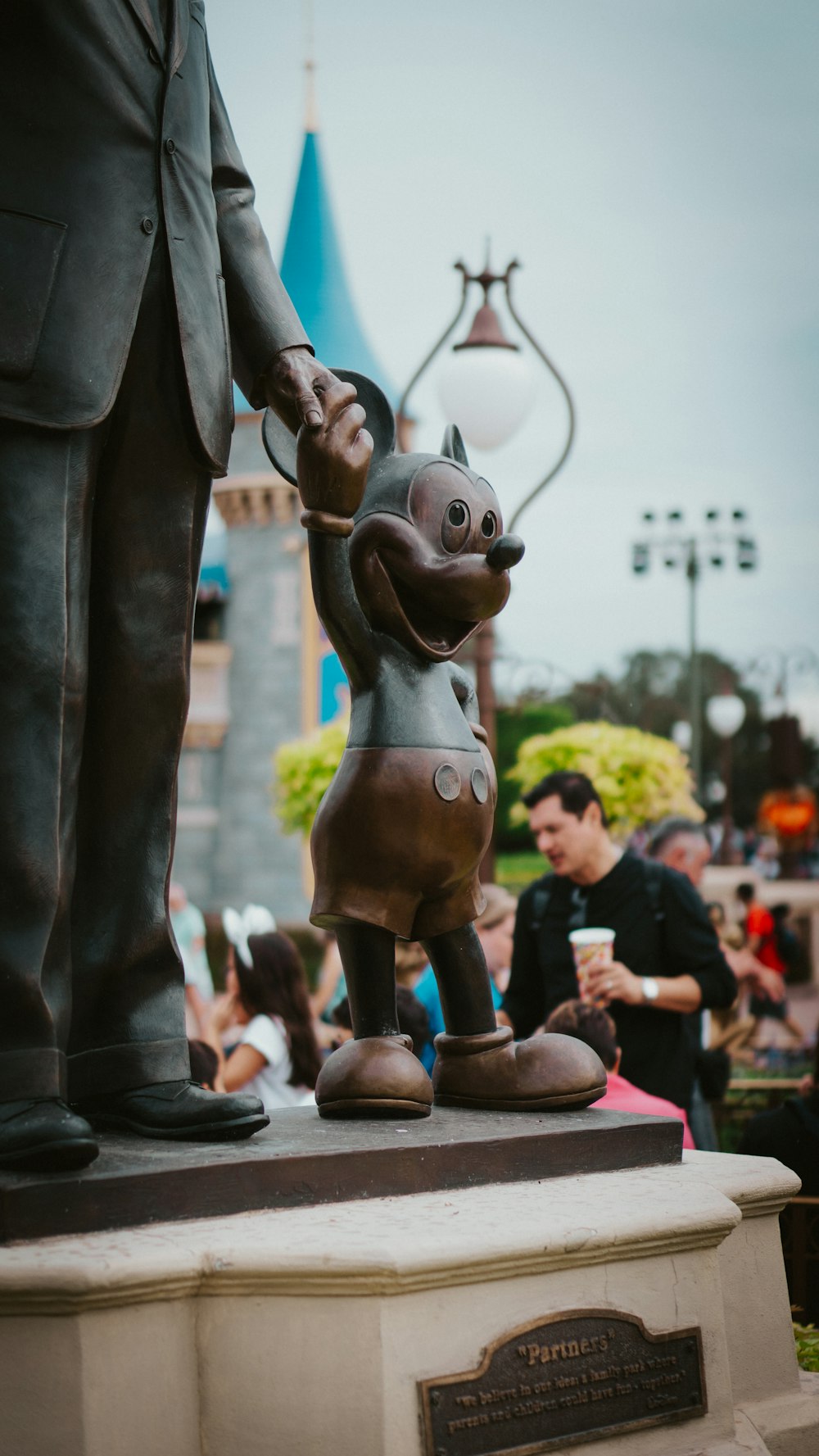 a statue of a man holding the hand of a dog