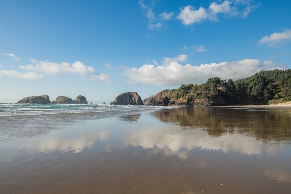 a beach that has some rocks in the water