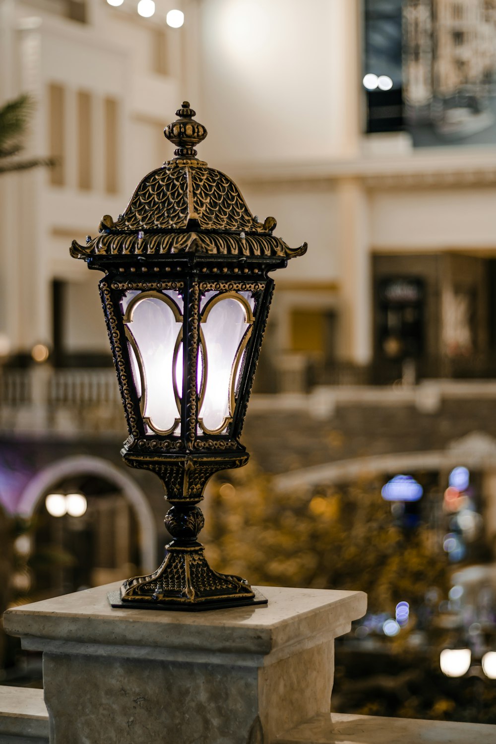 a lamp post in a mall with a building in the background