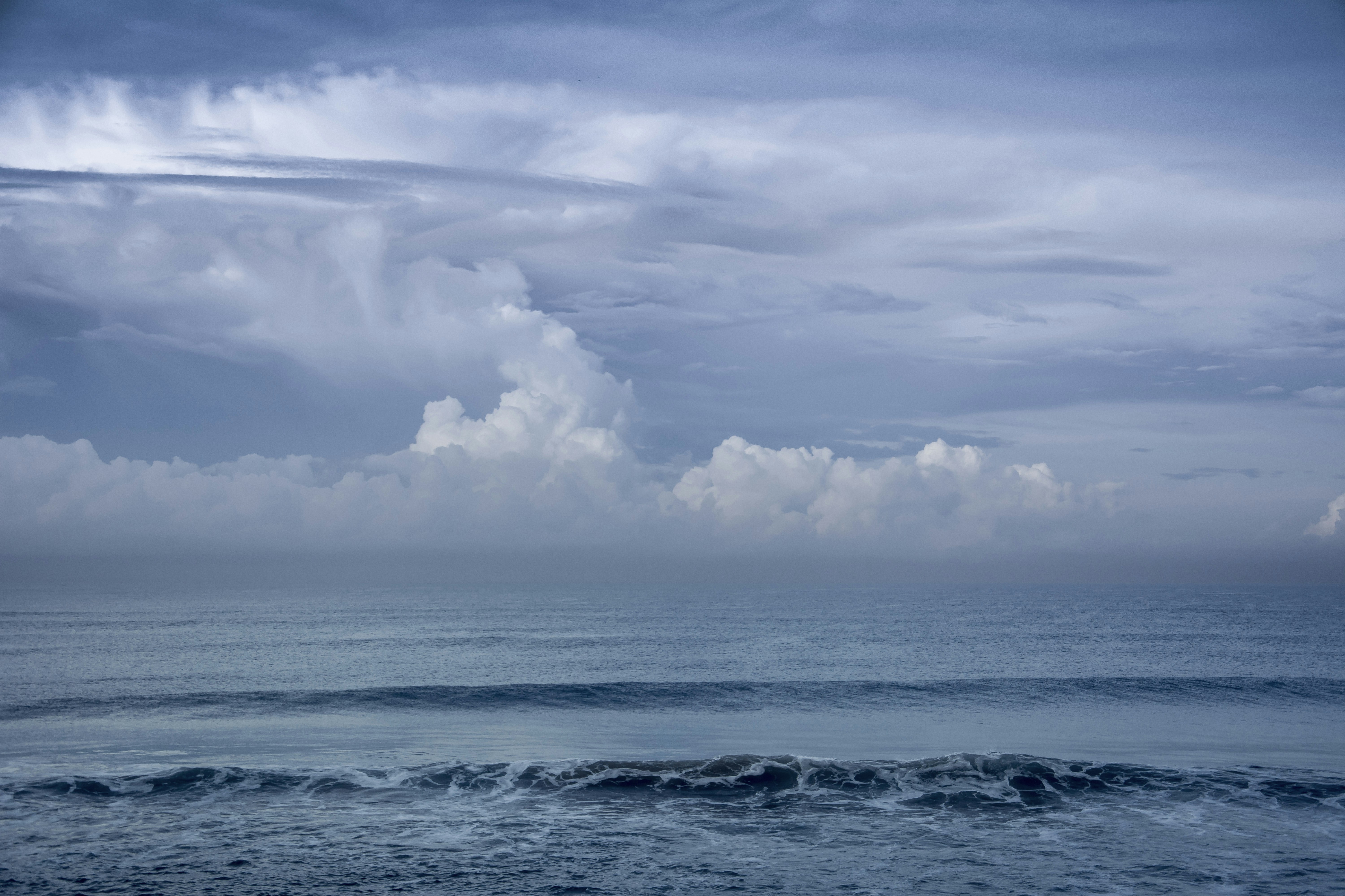 a large body of water under a cloudy sky