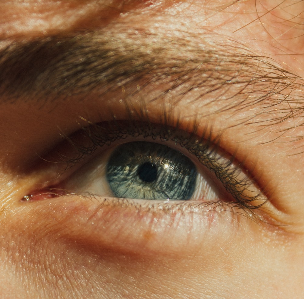 a close up of a person's blue eye