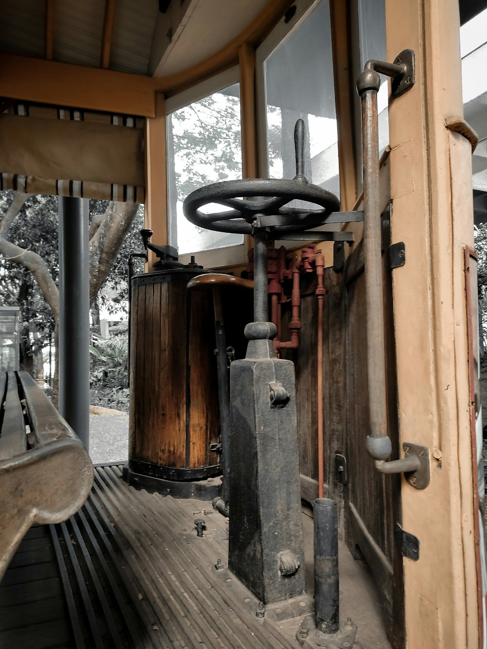 the inside of a building with pipes and a window