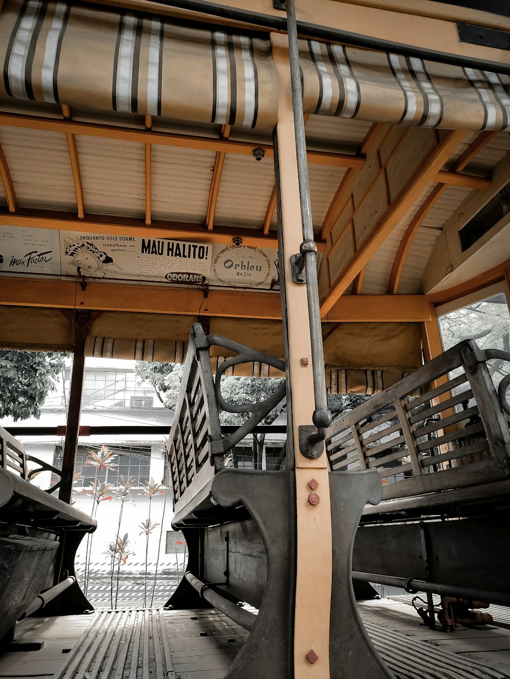 a couple of benches sitting under a roof