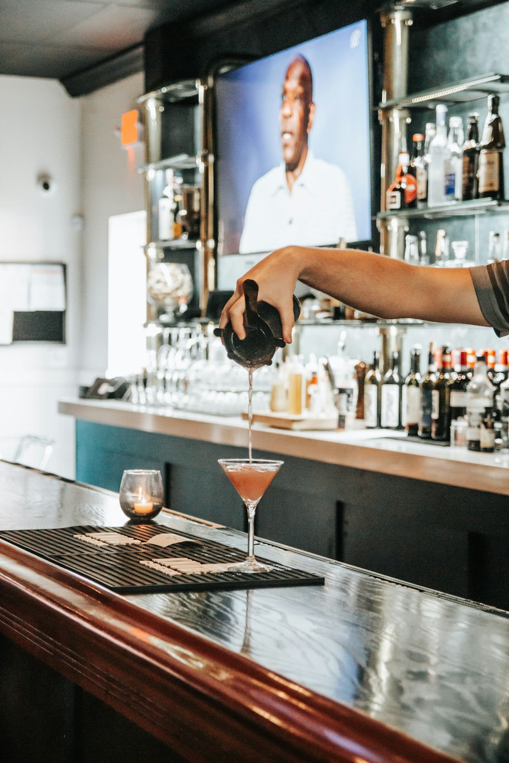 a bartender pours a drink at a bar