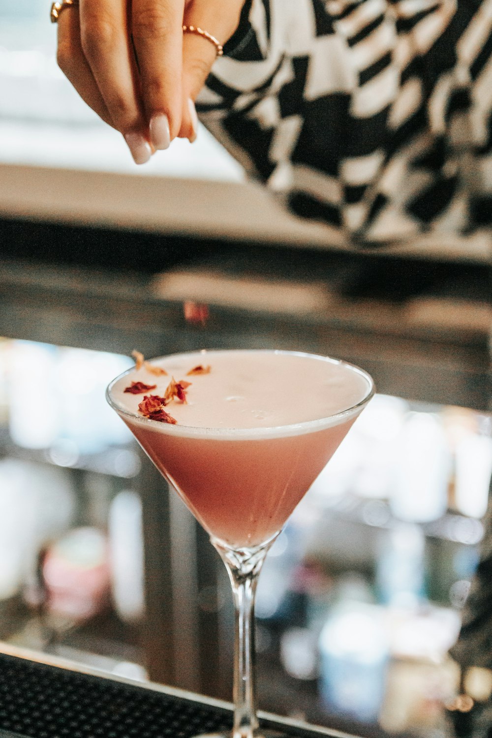 a close up of a person reaching for a drink