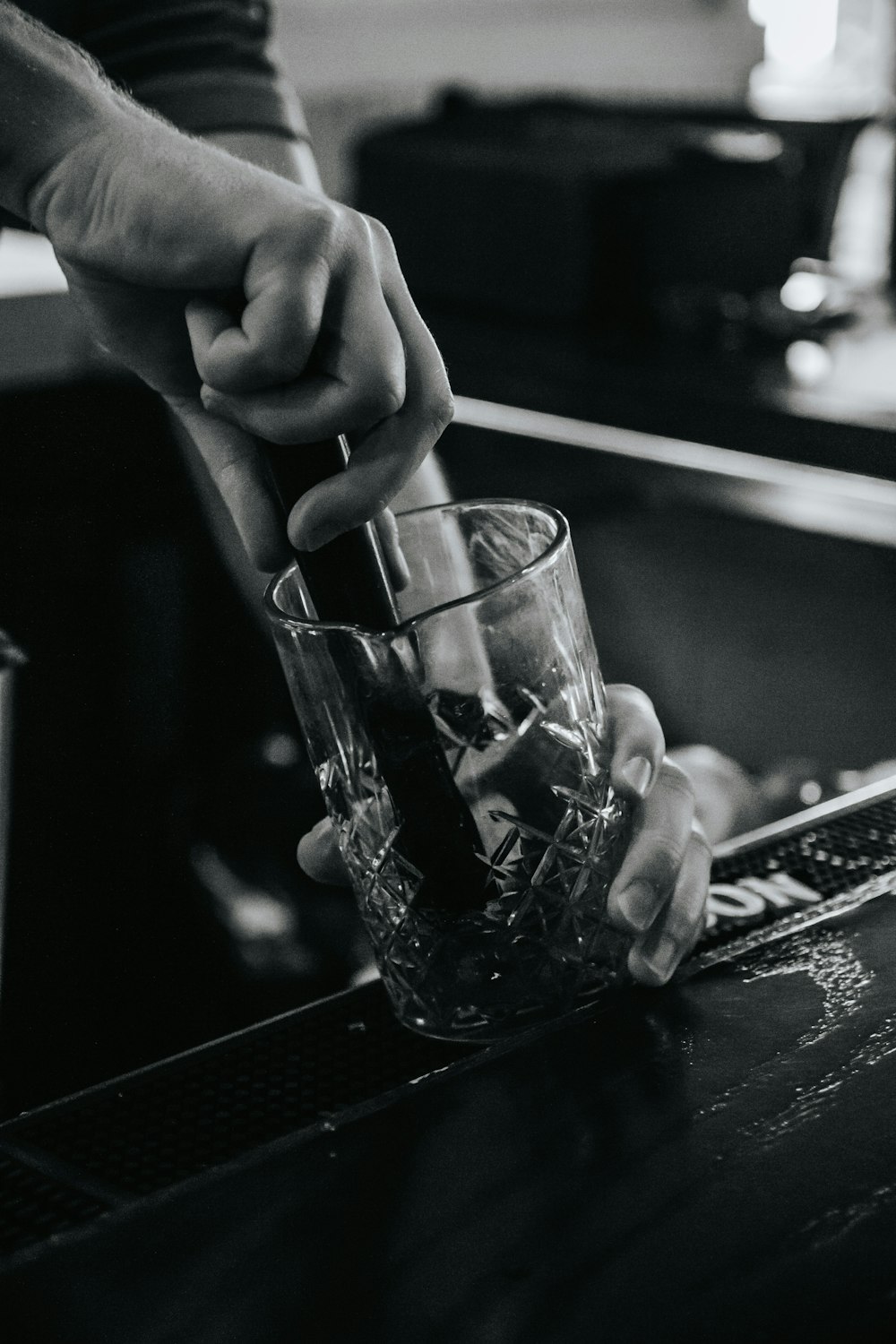 a person holding a glass with a drink in it