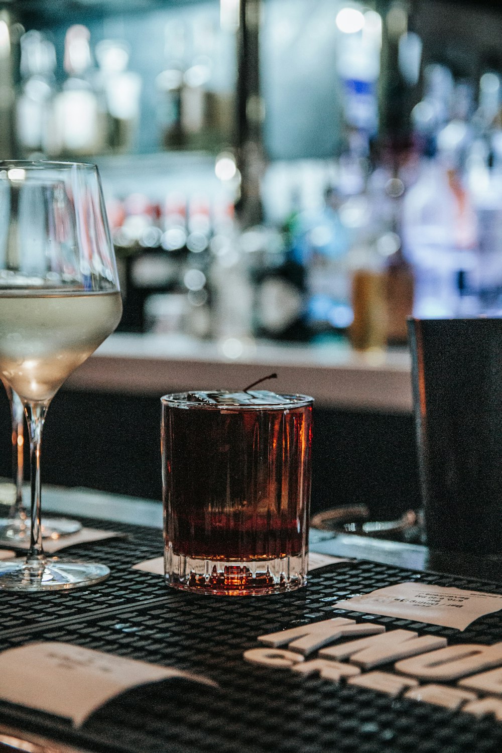 a glass of wine sitting on top of a table