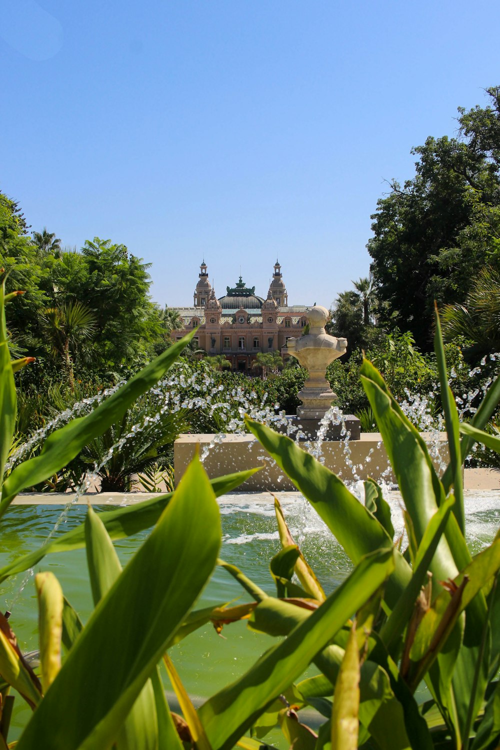 a large building with a fountain in front of it