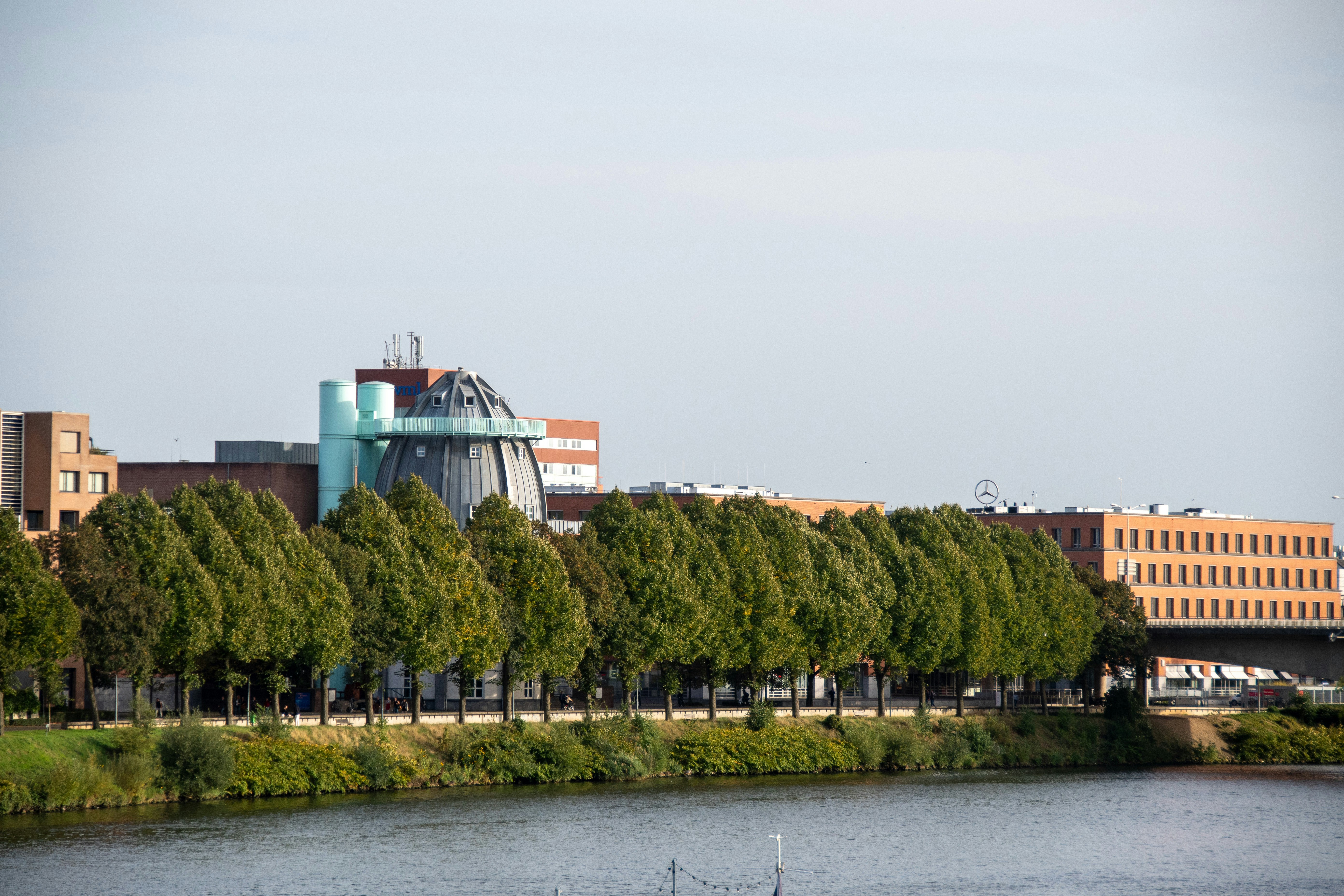 a large building with a tower next to a body of water