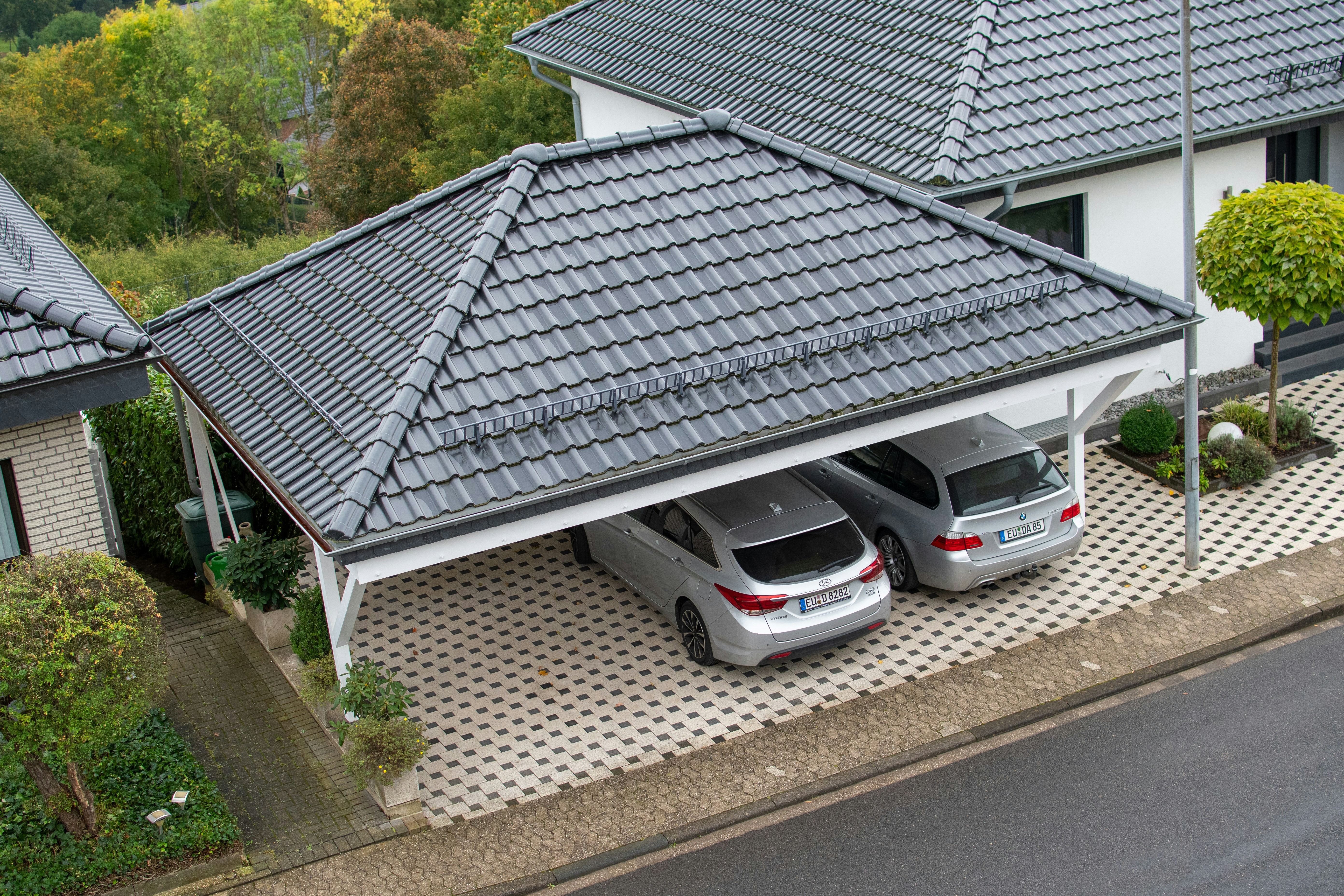 a couple of cars parked in front of a house