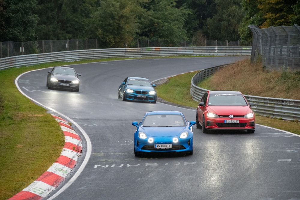 a group of cars driving down a race track