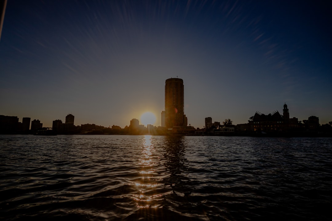 the sun is setting over a large body of water, River nile