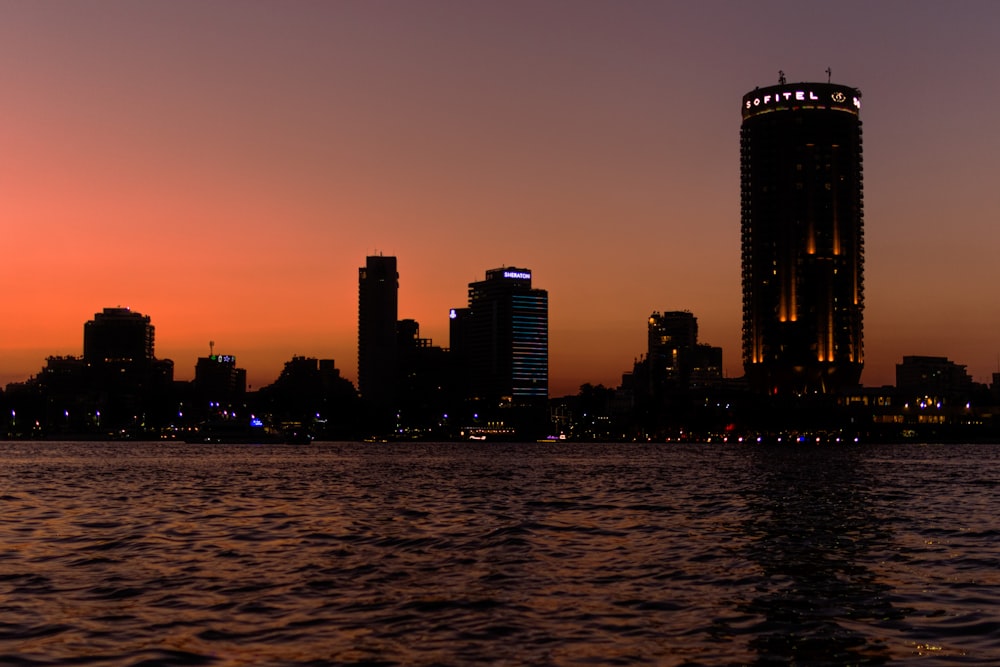 a large body of water with a city in the background