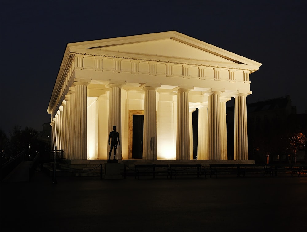 a man standing in front of a white building