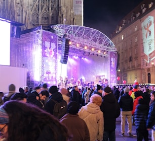 Live band performing on an outdoor stage with festive decorations and happy audience.