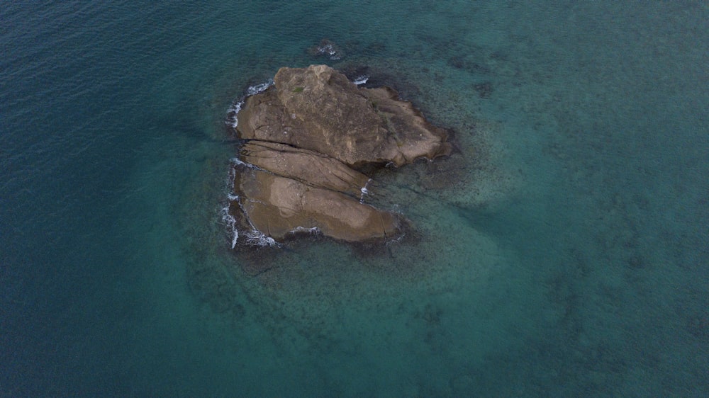 an aerial view of a rock formation in the ocean