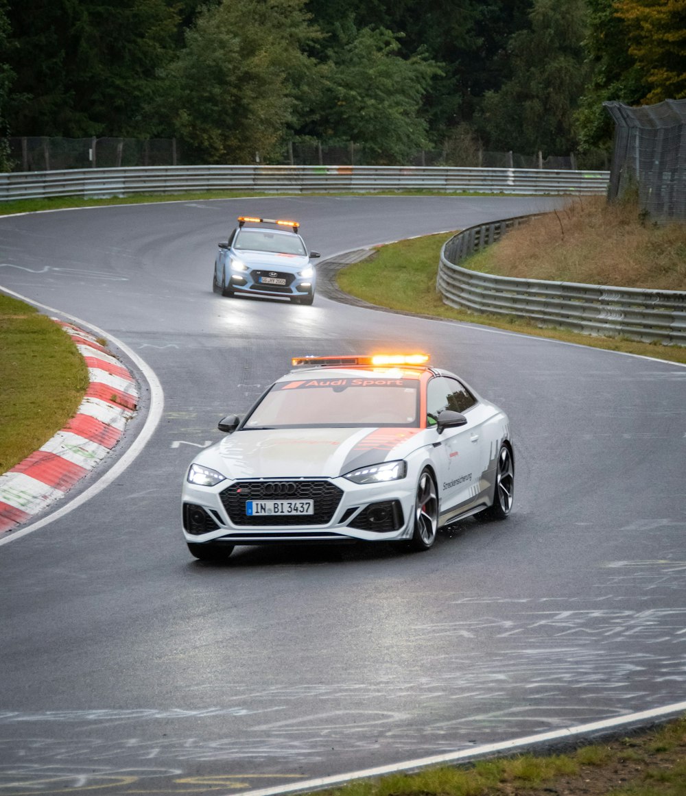 a police car driving down a race track