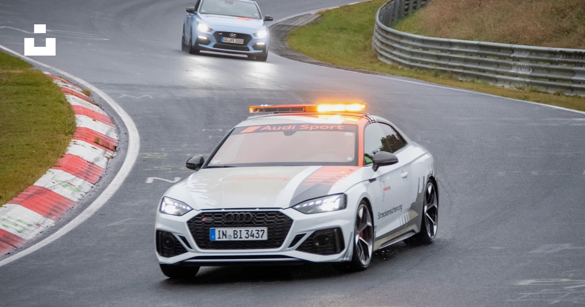 A police car driving down a race track photo – Free Germany Image on ...