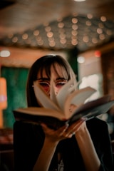 Smiling college student holding a book with vibrant overlay of hot pink.