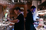 A friendly staff member serving drinks to customers.