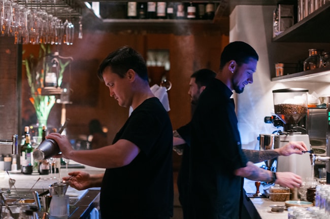 A friendly staff member serving drinks to customers.