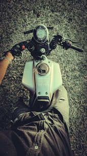 A rider reviewing detailed performance charts on a tablet beside their parked motorcycle.