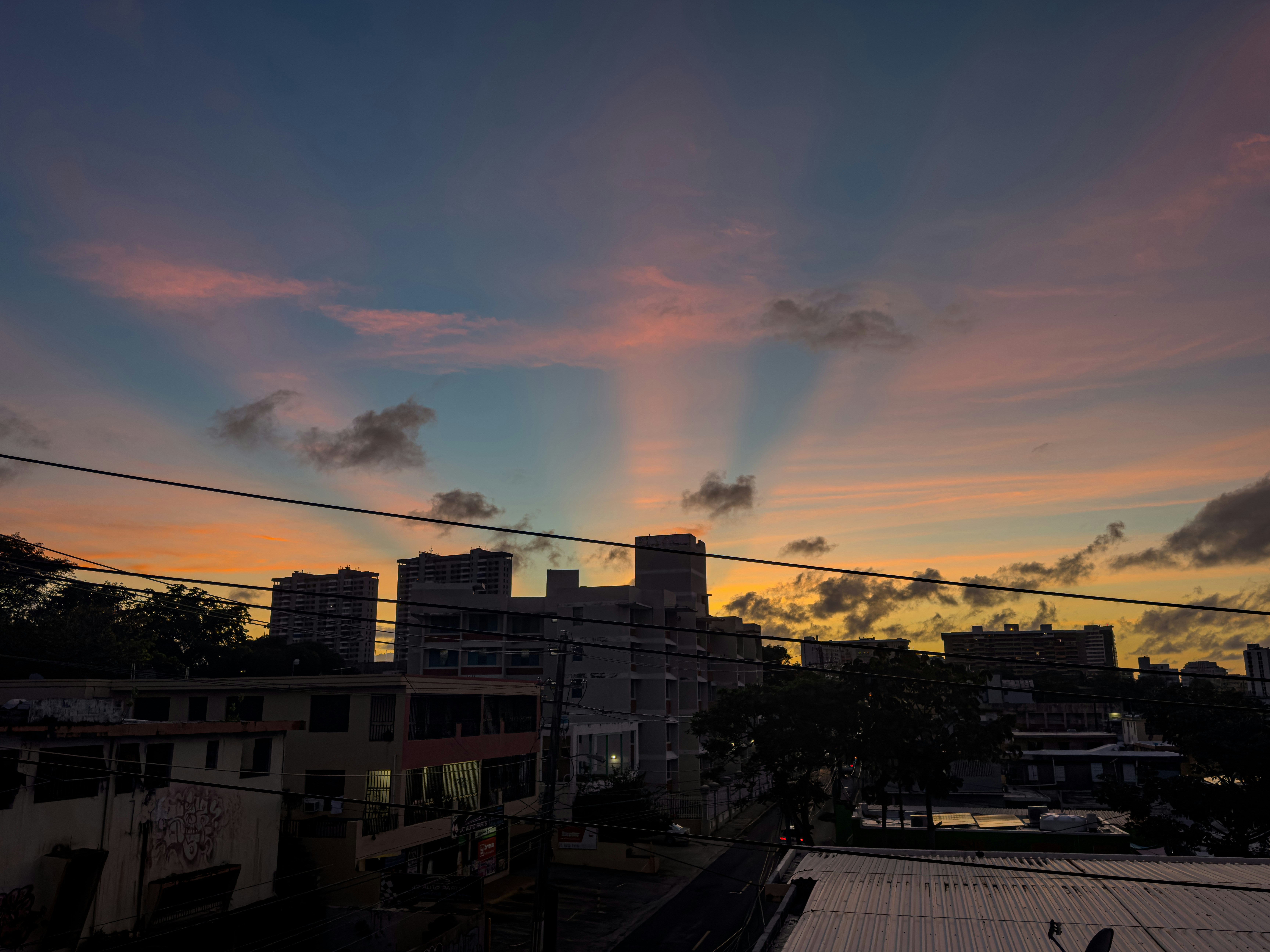 Sun rays behind buildings