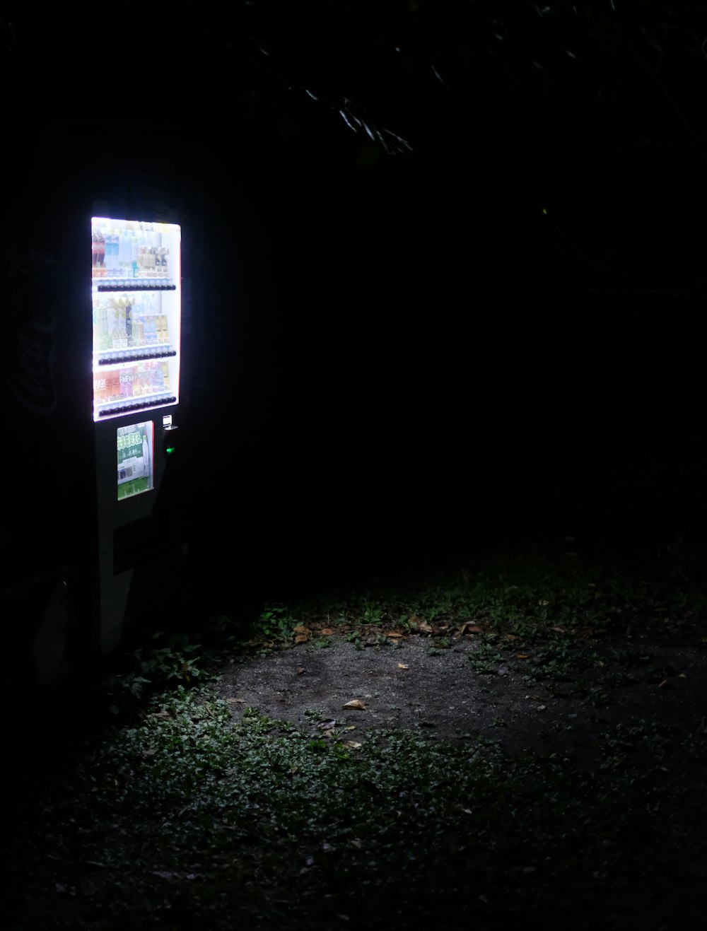 a vending machine lit up in the dark