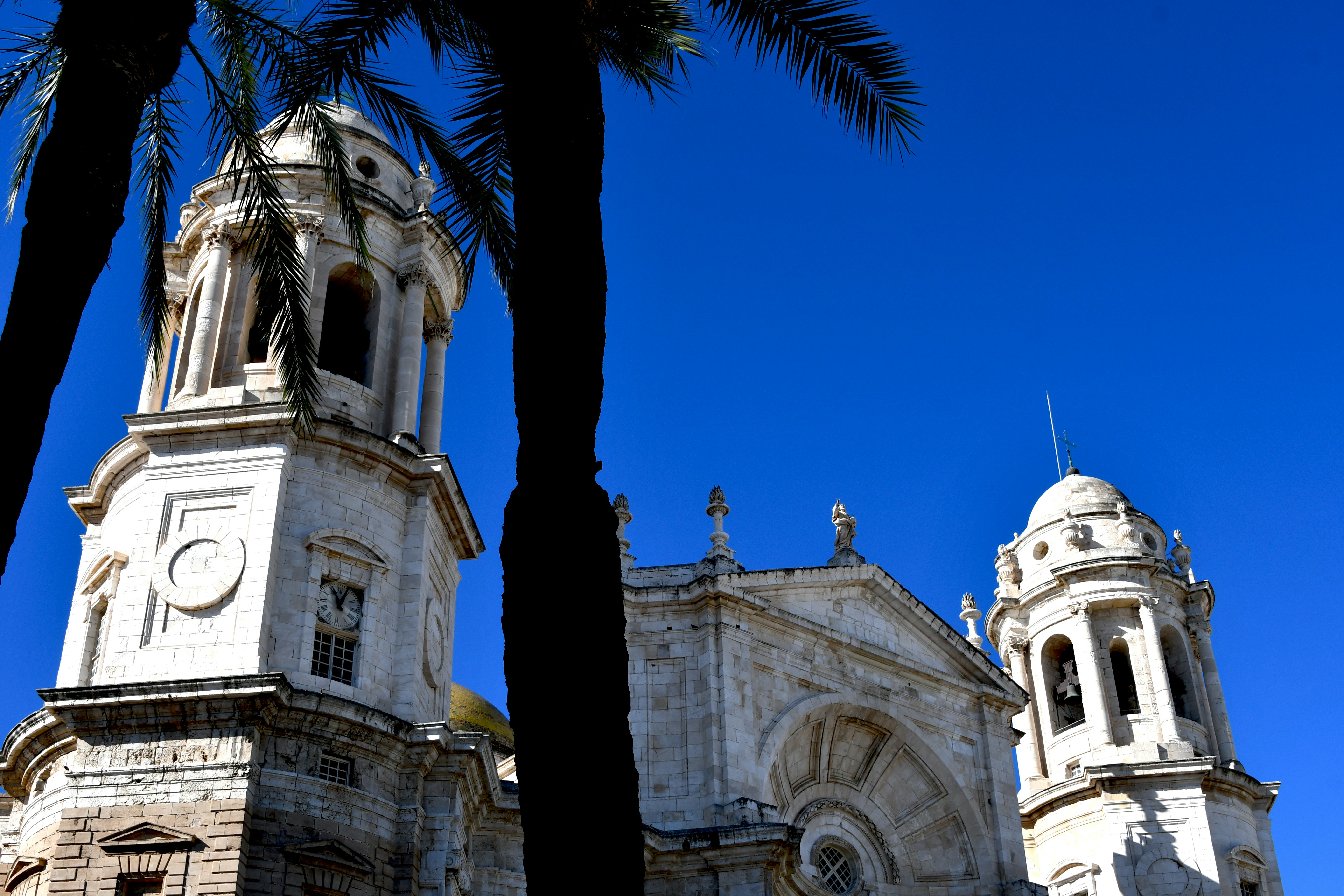 a tall white building with a clock on it